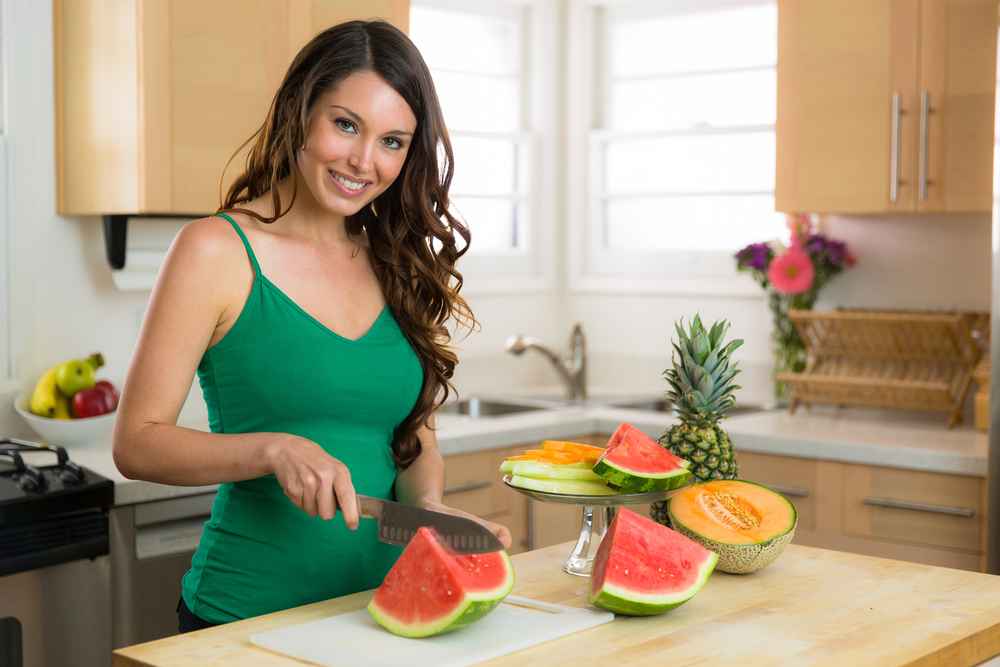 women cutting watermelon