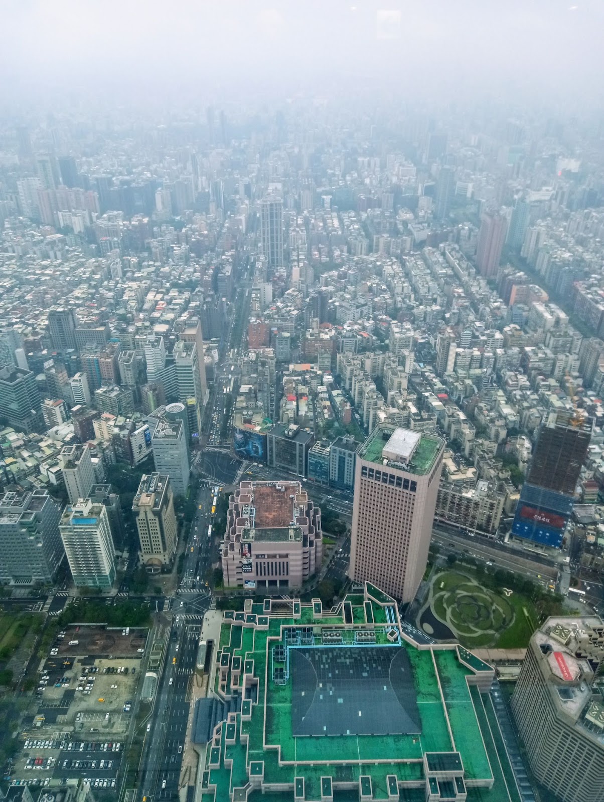 skyline of foggy taiwan showing skyscrapers and buildings in the background and greenery in the foreground