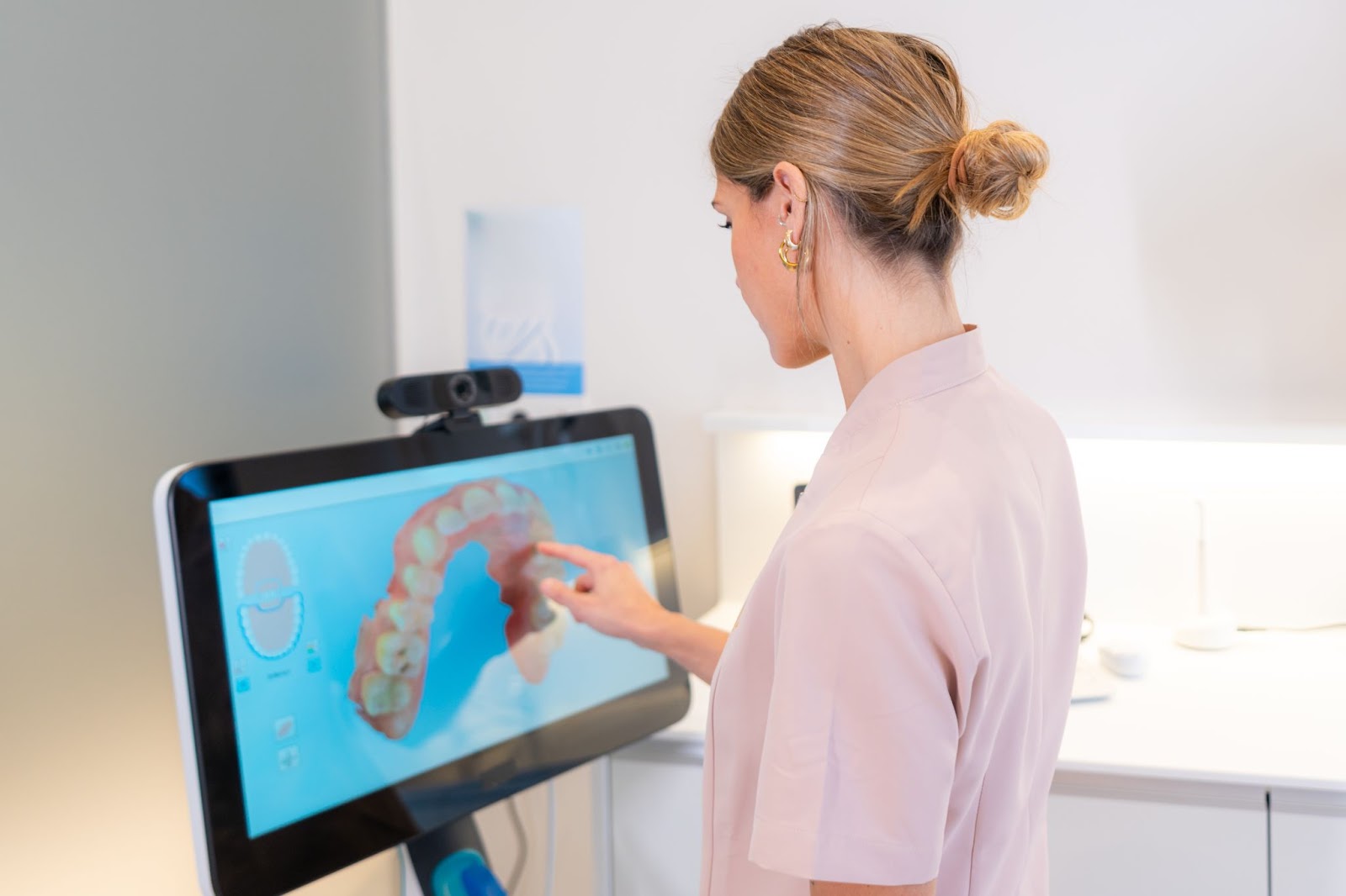 Woman looking at a 3D scan of teeth. 