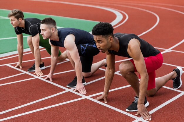 Athletes lined up on the track ready for a race.