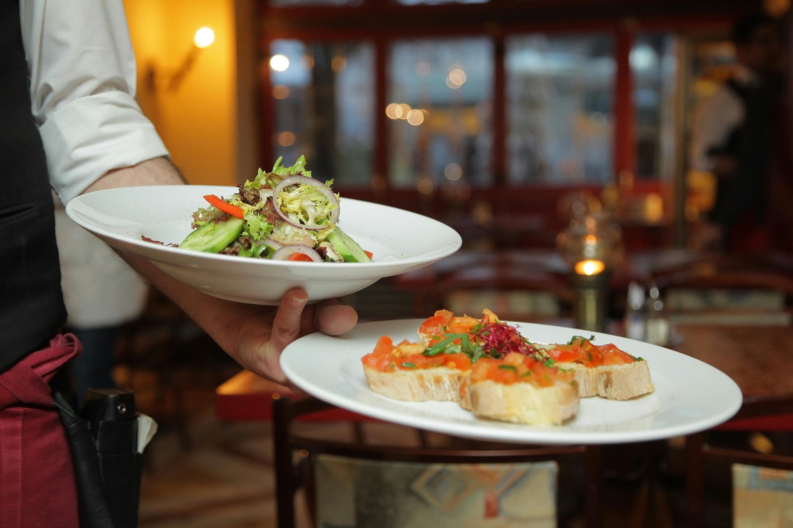 A couple enjoying a romantic dinner served by attentive waitstaff at the resort.