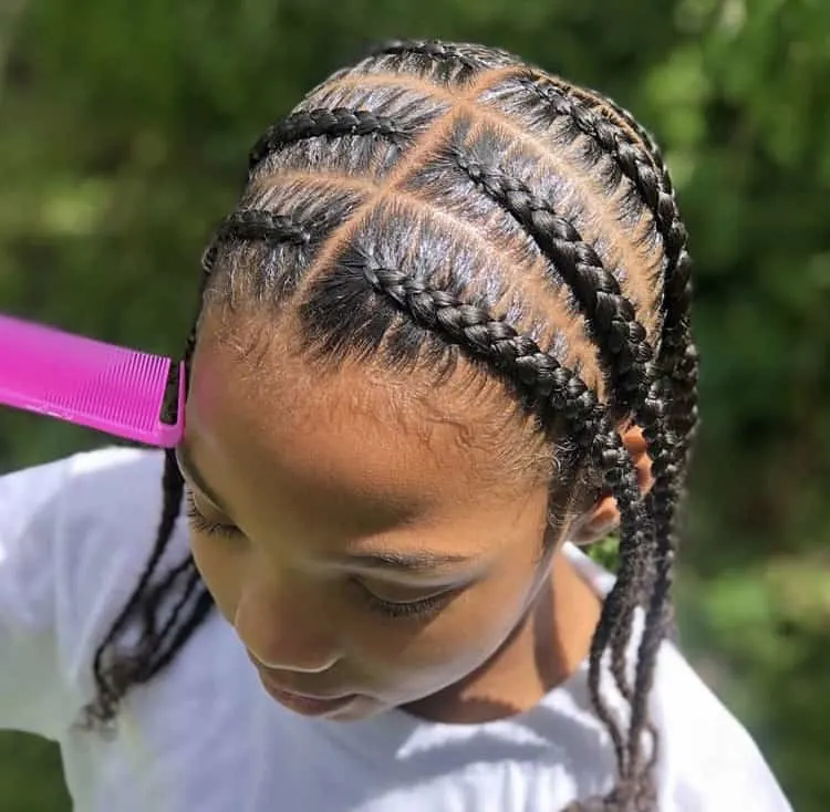 Beautiful picture showing a baby girl rocking the braids with her natural hair 