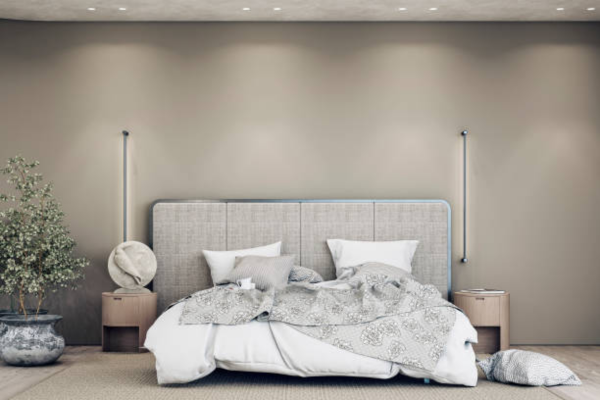 Grey bedroom with throws and sofa cushions