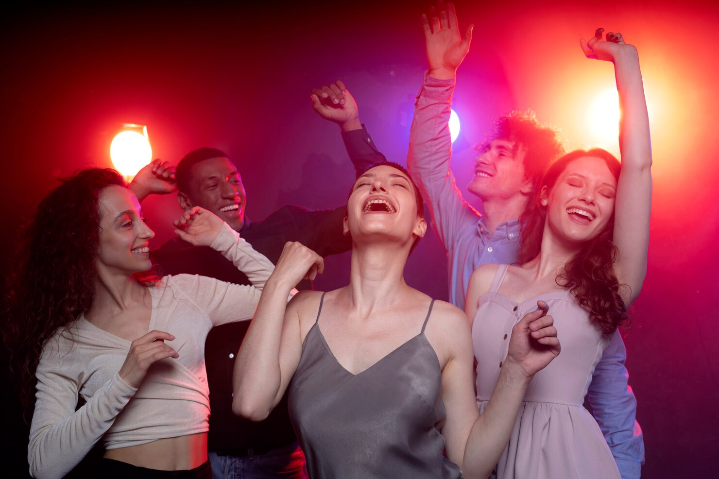 People dancing at a night club party. 