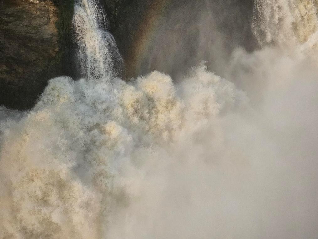 A waterfall with a rainbow