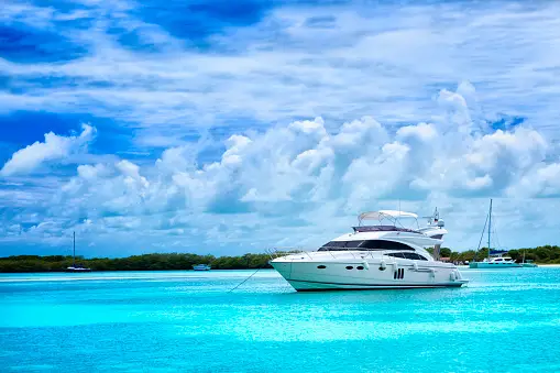 Luxury yacht anchored in a Tropical island turquoise beach