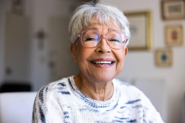 Portrait of a beautiful mixed race senior woman in her home A beautiful multiracial senior woman old people stock pictures, royalty-free photos & images