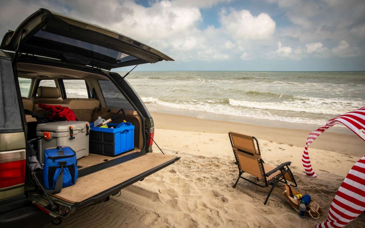 A tailgating setup at the beach just feet from the surf.