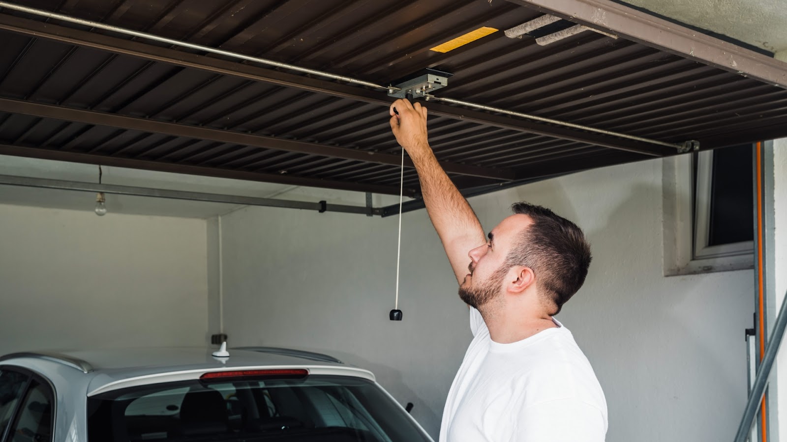 A man checking if his car would fit the newly installed garage door