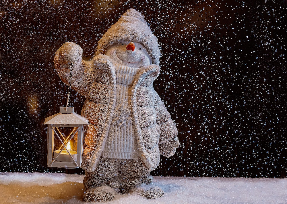 Snowman holding a lantern