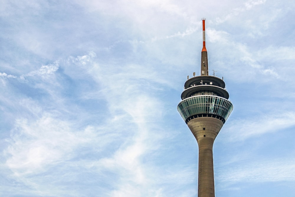 white and brown concrete tower under white clouds during daytime