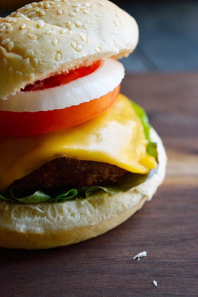 Air fried turkey burgers with cheese and tomato on a bun.