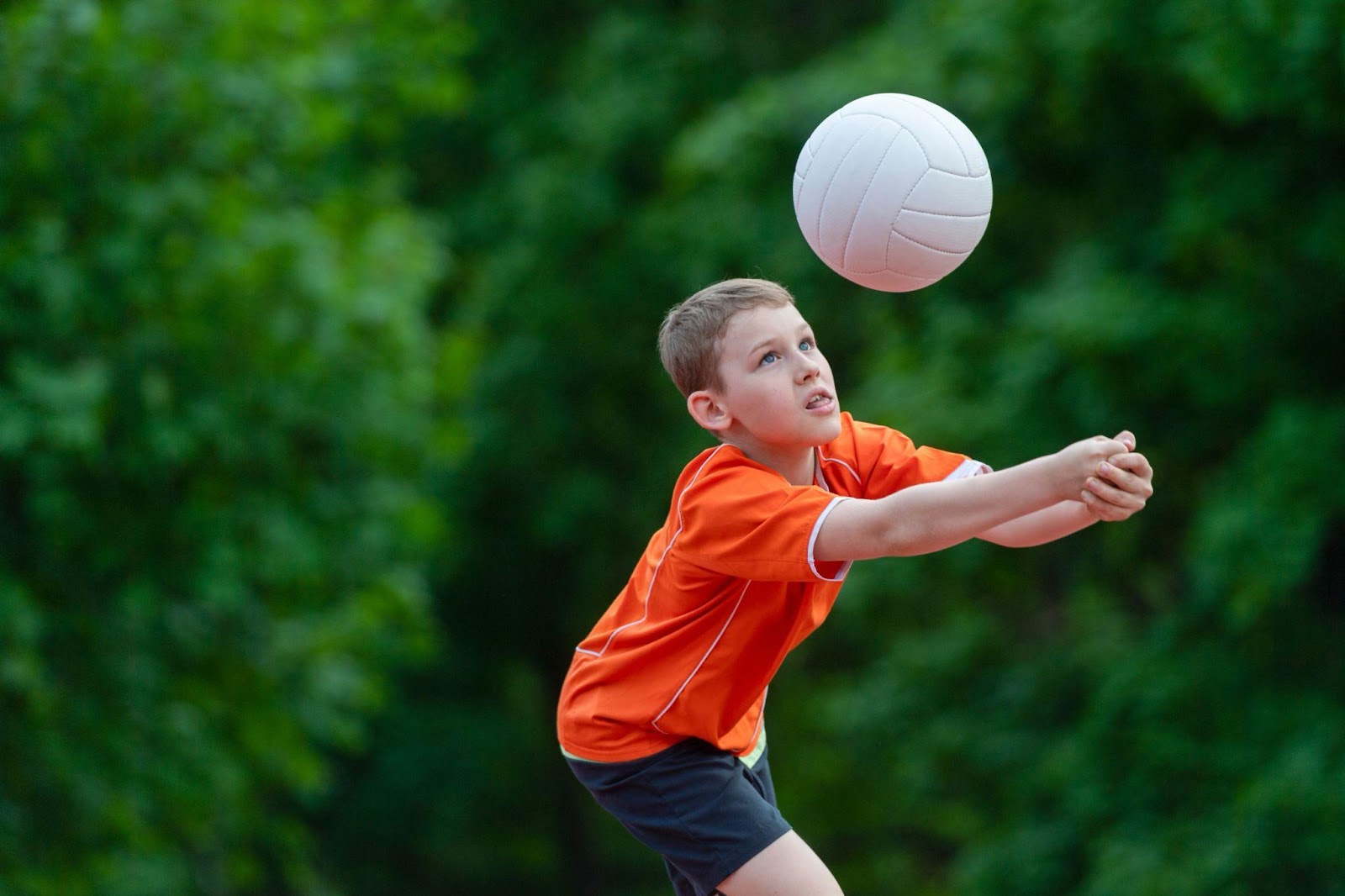 A boy playing volleyball