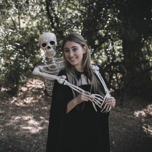 Skeleton standing behind laughing happy lady