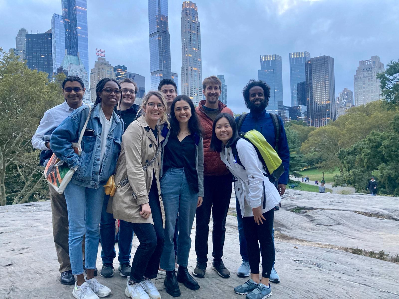 Group posing with the Manhattan skyline in the background.