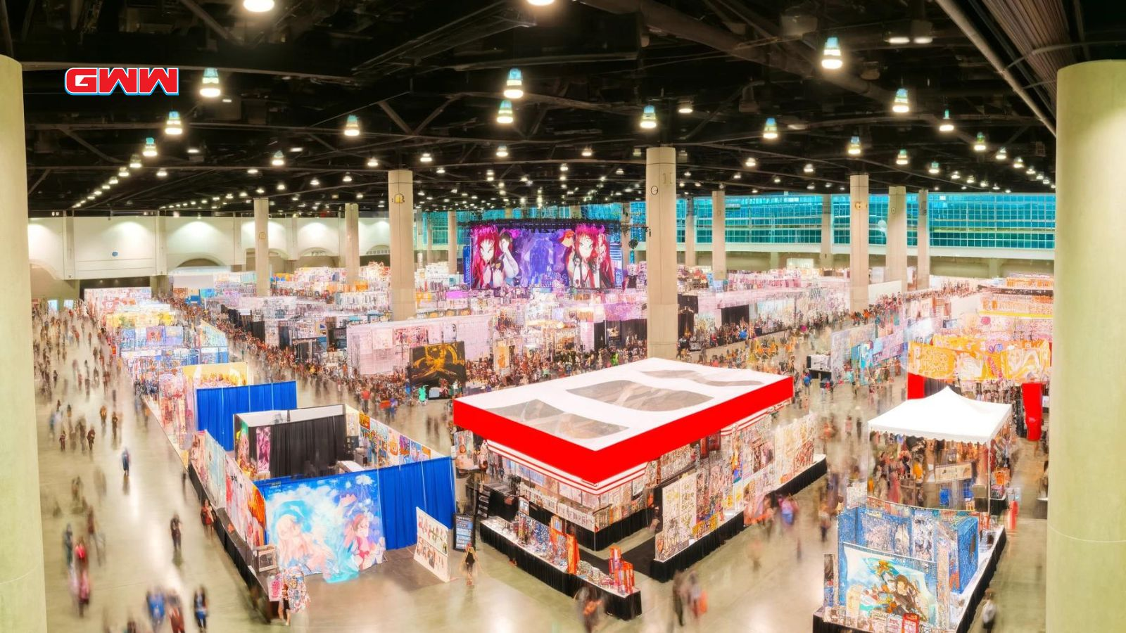 Indoor anime expo with bustling crowd and booths