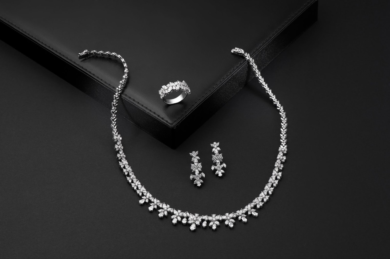 A diamond necklace and earrings.