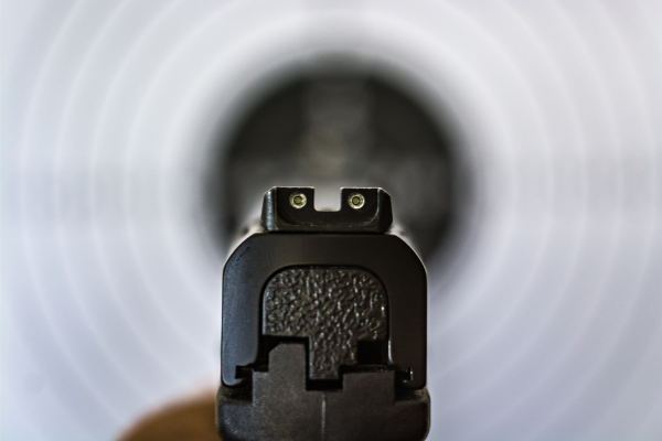 view from an iron sight on a pistol aiming at a target