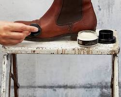 Image of Applying leather conditioner to Chelsea boots