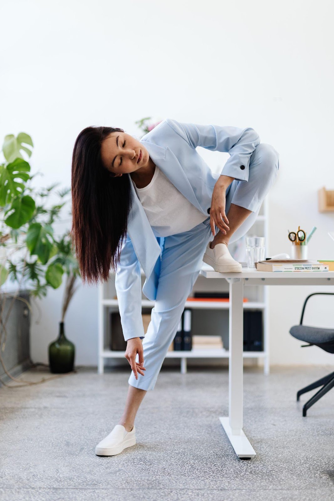 a woman stretching on her work desk