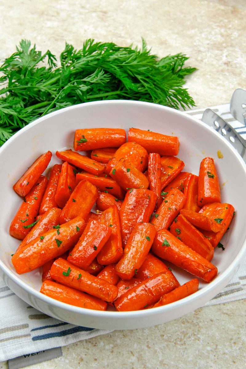 A white bowl with air fryer carrots in it.