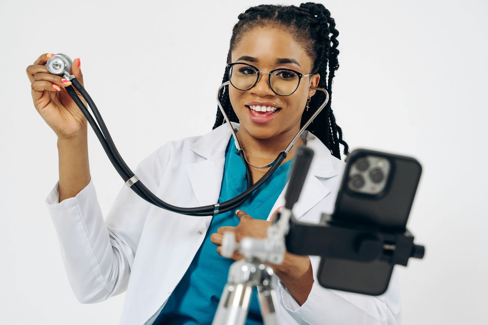 doctor holding a stethoscope in front of a camera