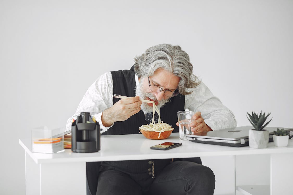 Free A Man Eating Noodles Stock Photo