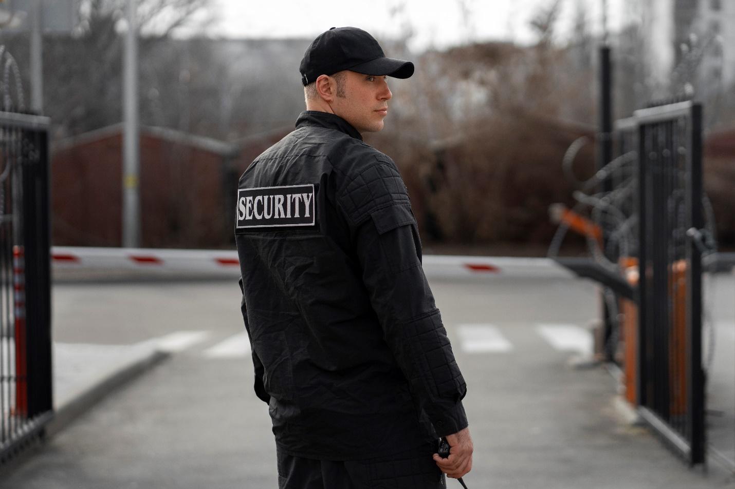 C:\Users\DELL\Downloads\portrait-male-security-guard-with-barbed-wire-fence.jpg