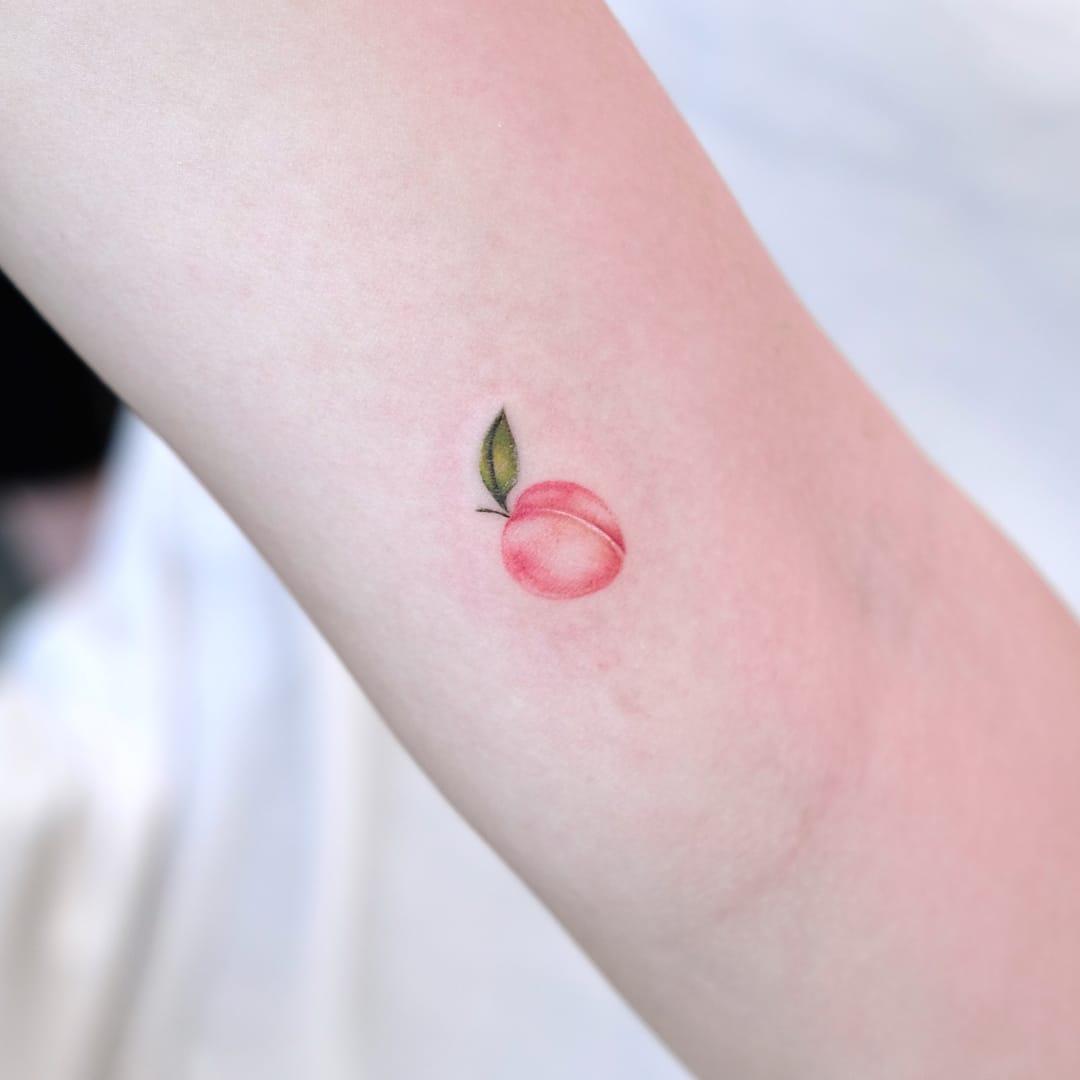 Tattoo uploaded by Tattoodo • Tiny baby peach tattoo by Siyeon #Siyeon  #peachtattoos #Koreanartist #peach #color #minimal #small #pink #fruit  #food #cute #nature • Tattoodo