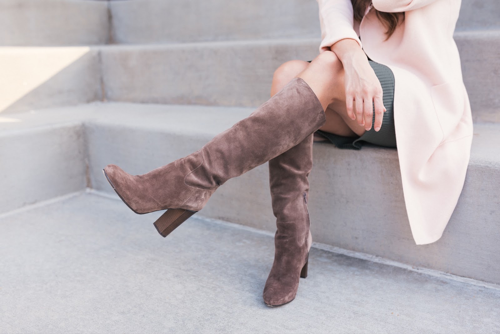 A women wearing stylish knee high boots to start her travel experience. 