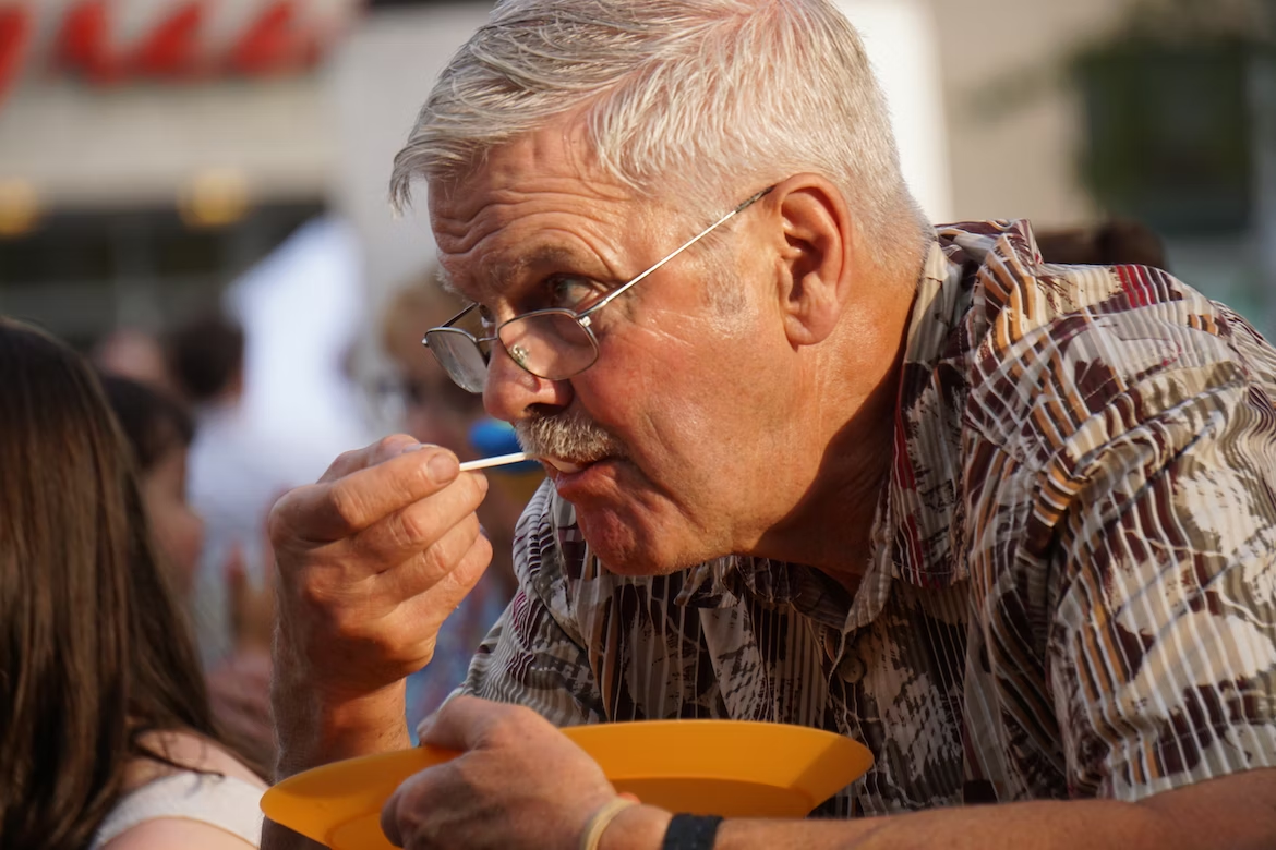 a senior eating a spoonful of ice cream