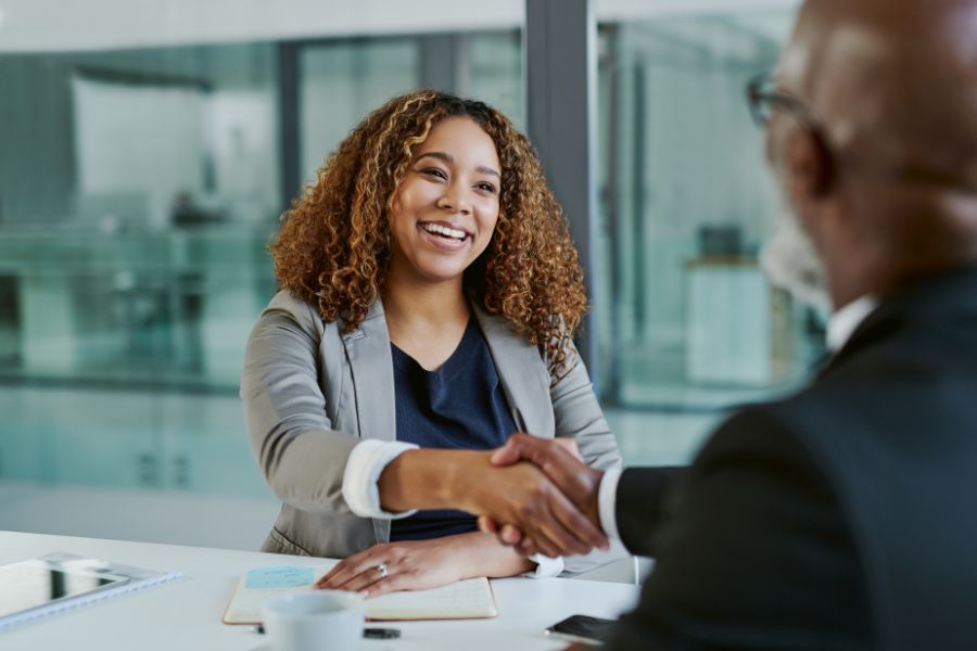 a smiling girl shaking hands to her mentor after the mentorship