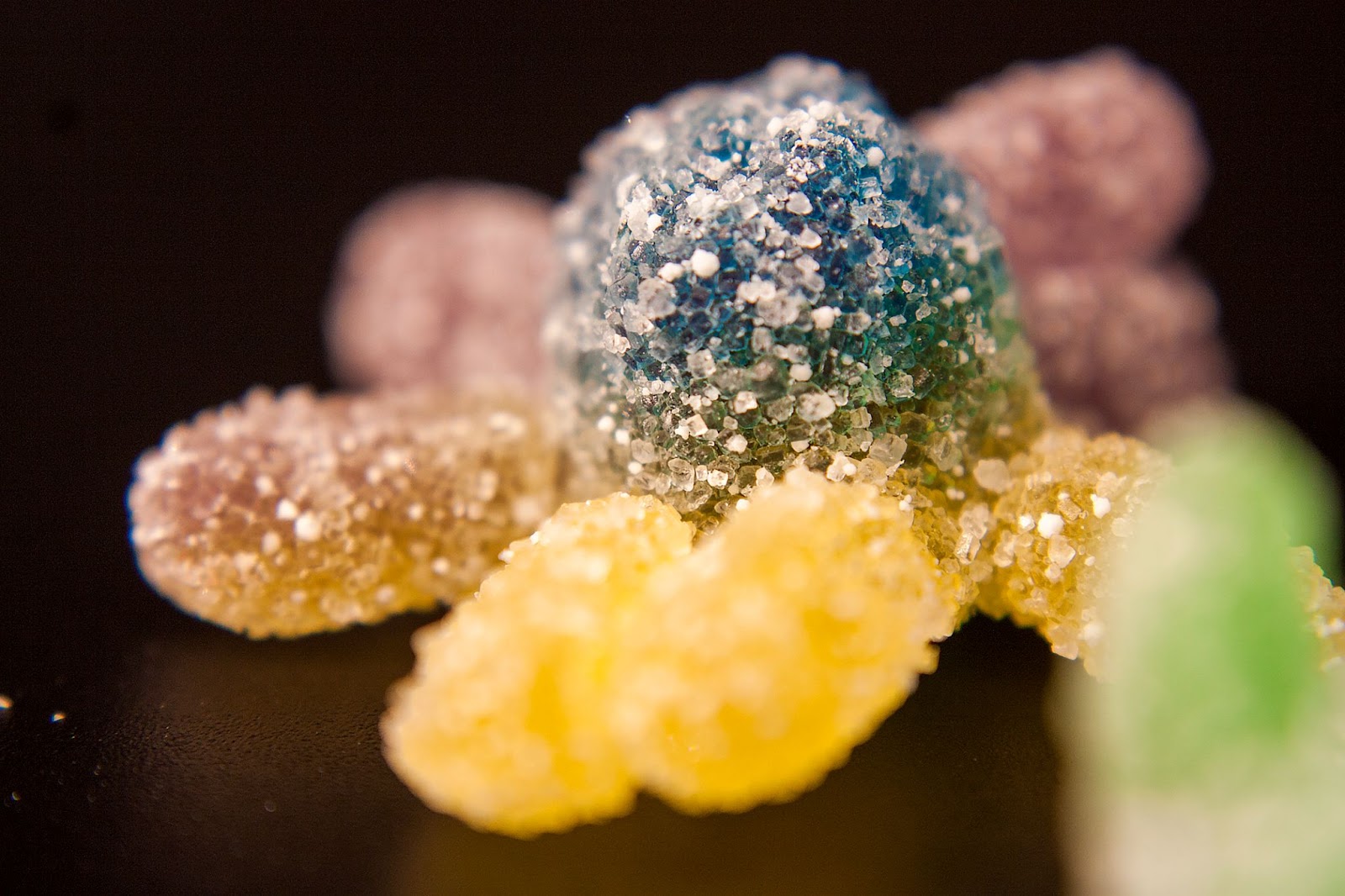 Close-up of sugar-coated sour gummy candies.