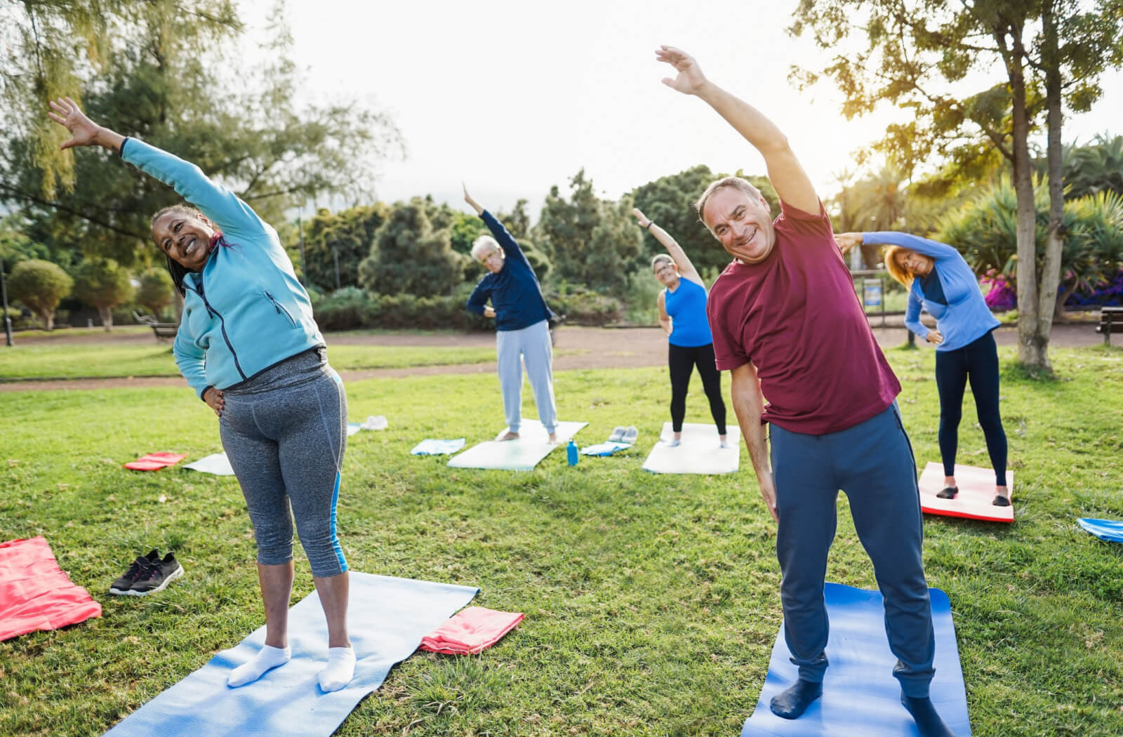 A group of active seniors stretching outdoors.