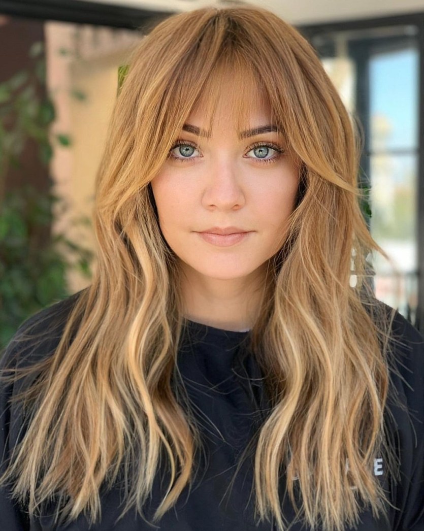 Picture of a lady  rocking her  Wispy Curtain Bangs