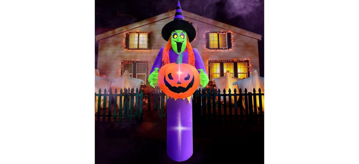 Giant Halloween inflatable witch holding pumpkin