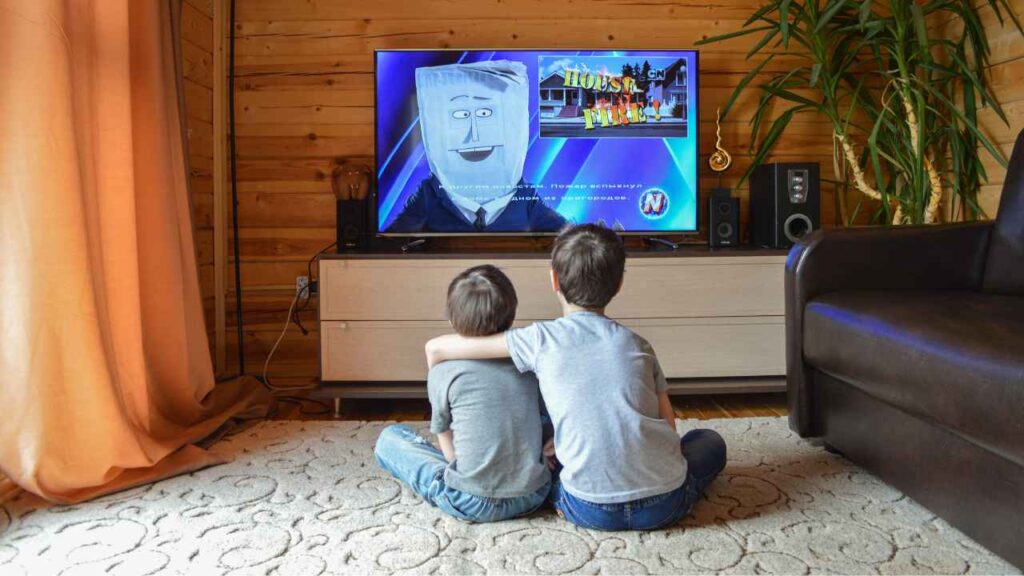 TWO KIDS WATCHING TV