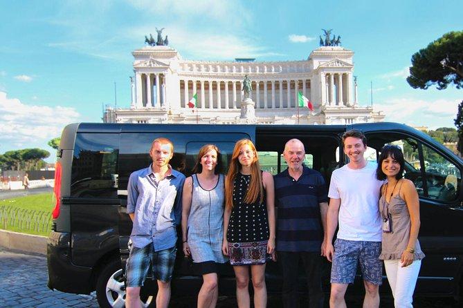 A group of people standing in front of a black van

Description automatically generated