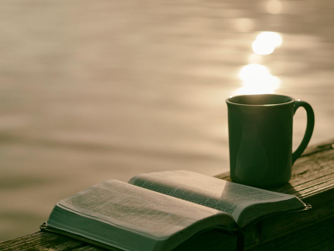 A bible beside a cup of coffee showing that Christian teachings can guide daily decisions, relationships, and moral dilemmas young people face.
