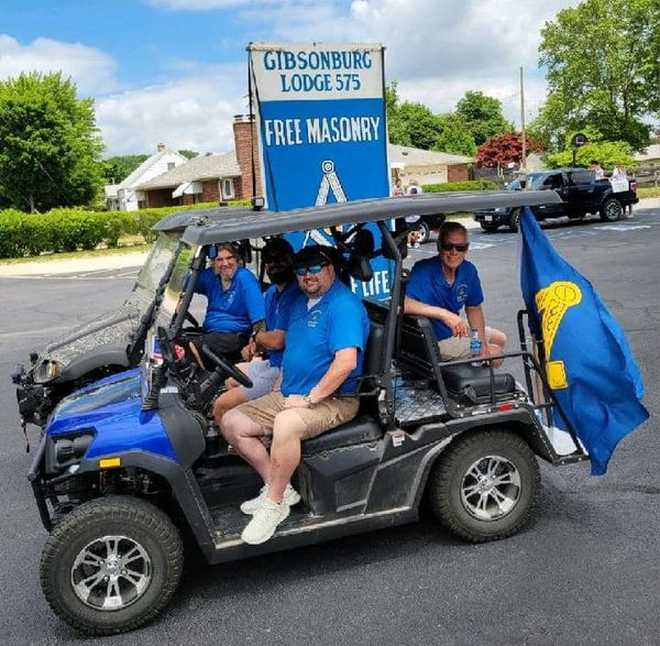 Image of Masons on golf cart for Gibsonburg Parade in 2023.