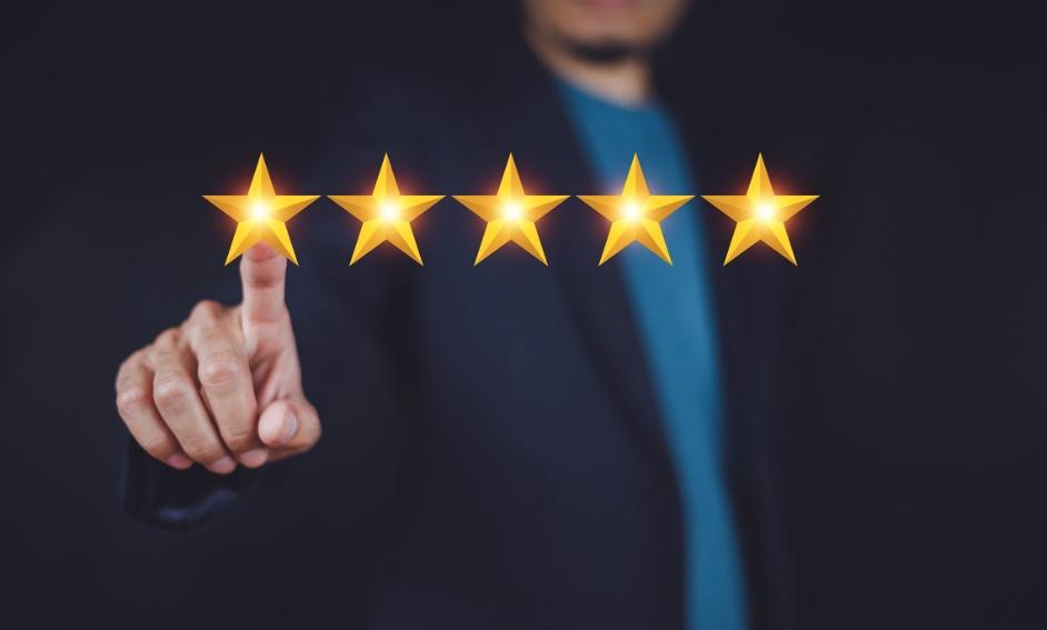 A person touching a five star rating

Description automatically generated