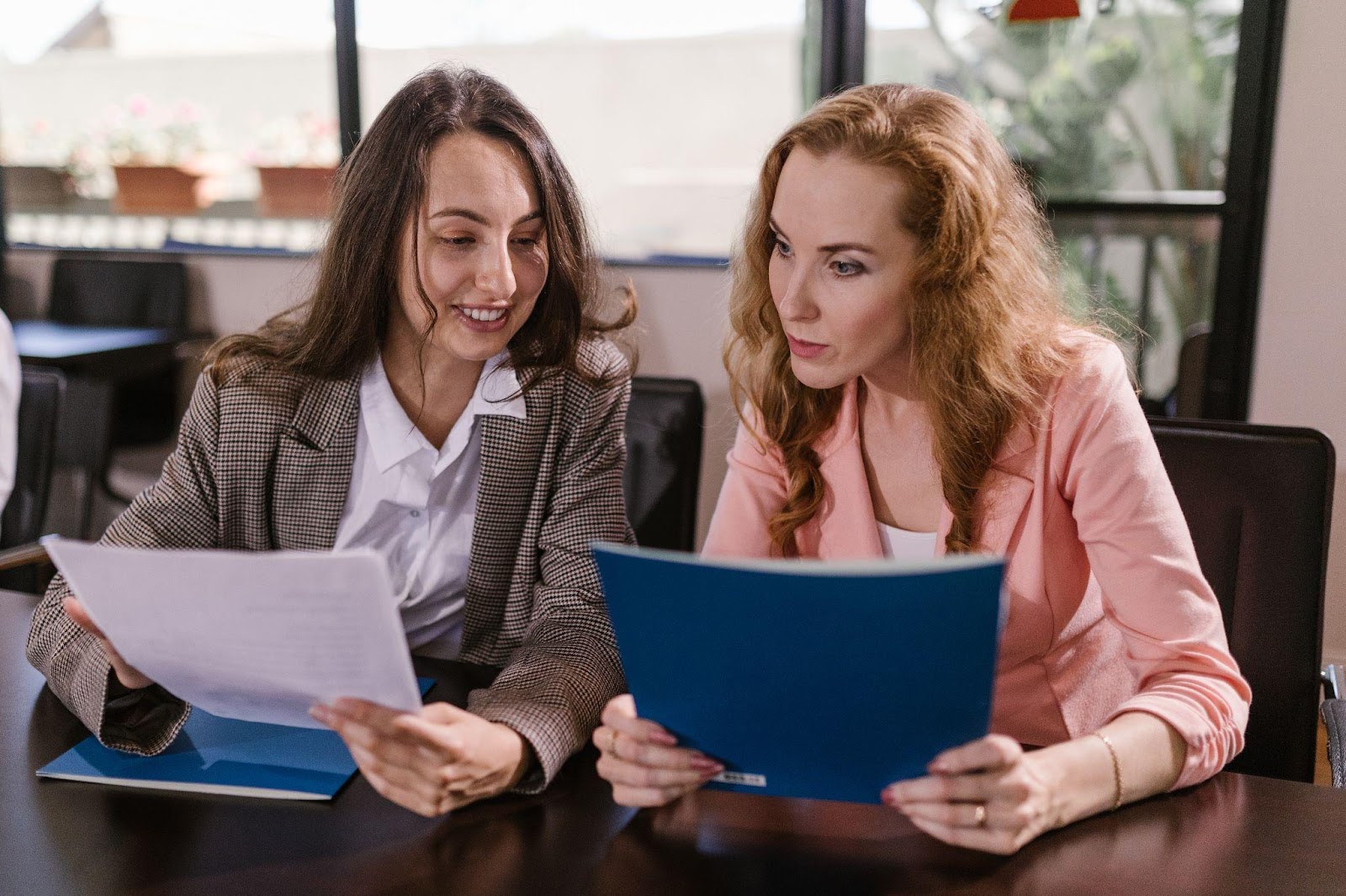 two women looking over candidate resumes