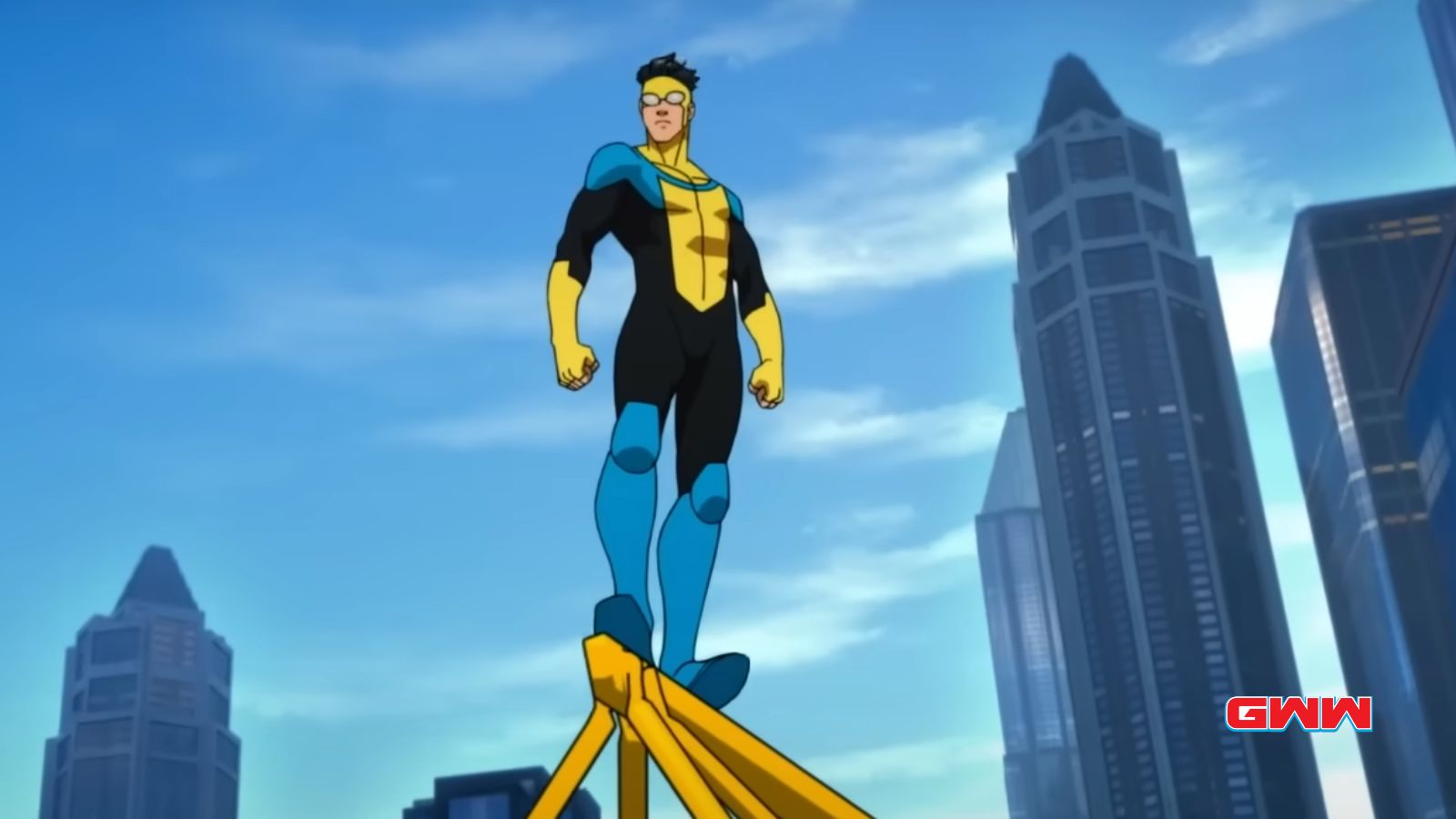 Invincible Superhero in blue and yellow suit standing confidently on a rooftop.