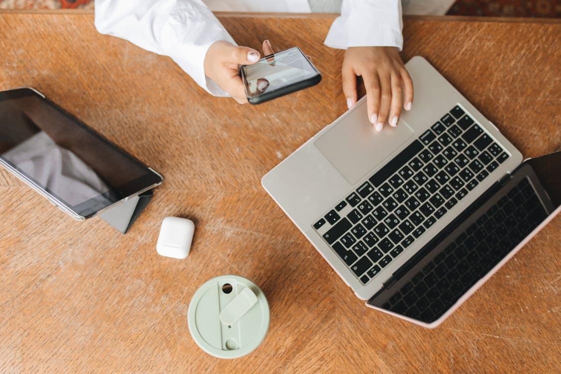 Free Person in White Dress Shirt Using Laptop Stock Photo