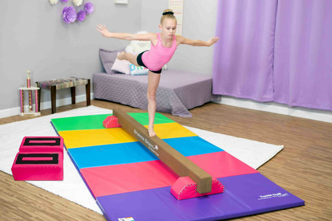 A child doing gymnastics on a tumbling track mat