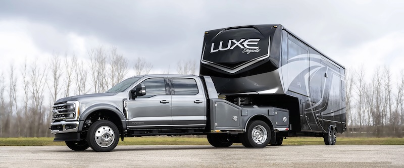 Luxe luxery 5th wheel brand RV connected to a large Ford truck