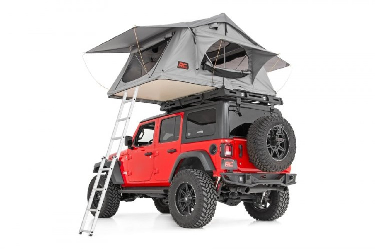 An overlanding and camping Polaris General roof rack, mounted on a jeep and holding a roof-mounted tent with included ladder.