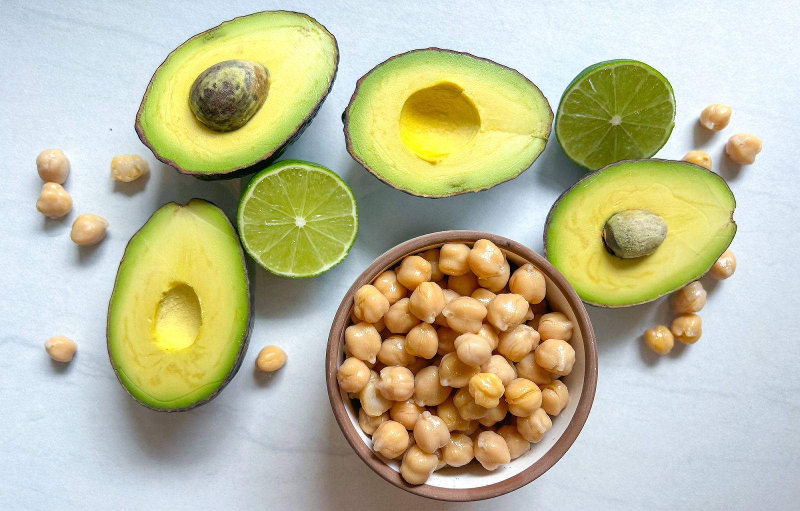 flat lay of avocado, chickpeas and limes