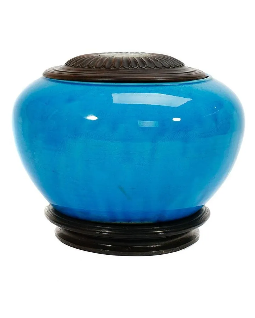 A blue jar with a black baseDescription automatically generated