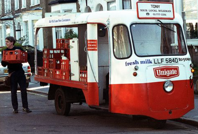 A red and white truck with a sign

Description automatically generated